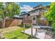 Charming backyard featuring a spacious deck, a concrete patio, mature trees and a privacy fence at 1451 N Gilpin St, Denver, CO 80218