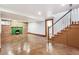 Finished basement with brick fireplace, concrete floor and staircase at 1451 N Gilpin St, Denver, CO 80218