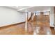 Unfurnished basement with concrete floors, brick accent wall, and staircase at 1451 N Gilpin St, Denver, CO 80218