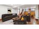 Staged basement with concrete floors, brick accent wall, fireplace and staircase at 1451 N Gilpin St, Denver, CO 80218