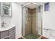 Bathroom with tiled shower stall, gray vanity and sink at 1451 N Gilpin St, Denver, CO 80218