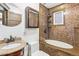 Bathroom features a tiled shower over tub, granite countertop sink, and a vanity mirror at 1451 N Gilpin St, Denver, CO 80218