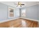 Cozy bedroom with hardwood floors, neutral paint and natural light from two windows at 1451 N Gilpin St, Denver, CO 80218