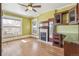 Bedroom with light green walls features a fireplace, hardwood floors, and a large window at 1451 N Gilpin St, Denver, CO 80218