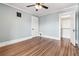 Bedroom featuring hardwood floors, ceiling fan, closet and a large door at 1451 N Gilpin St, Denver, CO 80218