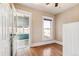Bedroom with hardwood floors and a doorway leading to an enclosed sunroom at 1451 N Gilpin St, Denver, CO 80218