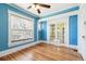 Bedroom with an abundance of natural light, showcasing hardwood floors and access to another room at 1451 N Gilpin St, Denver, CO 80218