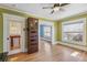 Bedroom features hardwood floors, light green walls, and a view into the hallway and another room at 1451 N Gilpin St, Denver, CO 80218