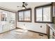 A bright breakfast nook with white walls and tile floors sits between a doorway and two windows at 1451 N Gilpin St, Denver, CO 80218