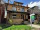 Beautiful two-story home with a welcoming front porch and professional real estate signage at 1451 N Gilpin St, Denver, CO 80218