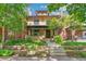 Charming two-story brick home featuring a landscaped front yard, covered porch, and a classic architectural design at 1451 N Gilpin St, Denver, CO 80218
