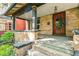 Charming front porch featuring brick columns, a decorative front door, and ample space for outdoor seating at 1451 N Gilpin St, Denver, CO 80218
