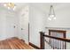 Bright hallway features hardwood floors, white walls with wood trim, and vintage light fixtures at 1451 N Gilpin St, Denver, CO 80218