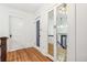 Bright hallway features hardwood floors, white trim and mirrored closet doors at 1451 N Gilpin St, Denver, CO 80218