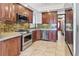 Well-lit kitchen features stainless steel appliances, granite countertops and stone tile backsplash at 1451 N Gilpin St, Denver, CO 80218