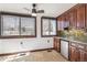Bright breakfast nook features two windows with wood trim, a ceiling fan, and wooden cabinets at 1451 N Gilpin St, Denver, CO 80218