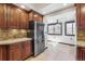 Bright kitchen features stainless steel refrigerator, tile flooring, and wooden cabinets at 1451 N Gilpin St, Denver, CO 80218