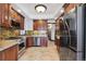 Kitchen featuring stainless steel appliances, granite countertops, and wood cabinets at 1451 N Gilpin St, Denver, CO 80218