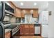 Kitchen featuring stainless steel appliances and silver backsplash, including a washer and dryer at 1451 N Gilpin St, Denver, CO 80218