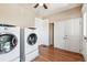Spacious laundry room with a washer, dryer, hardwood floors, and closet space at 1451 N Gilpin St, Denver, CO 80218