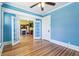 Bright blue living room with hardwood floors and view into the fireplace room at 1451 N Gilpin St, Denver, CO 80218