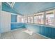 Bright sunroom with tile flooring, wood paneled walls and ample windows for natural light at 1451 N Gilpin St, Denver, CO 80218