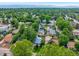 Aerial view of the neighborhood with mature trees and mountain views at 2535 S Julian St, Denver, CO 80219