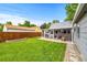 Spacious backyard with lush lawn, covered patio, and detached garage, great for entertaining at 2535 S Julian St, Denver, CO 80219