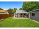 Well-maintained backyard features lush green grass, detached garage, and a cozy patio at 2535 S Julian St, Denver, CO 80219