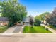 Well-maintained house with a beautiful lawn and driveway at 2535 S Julian St, Denver, CO 80219