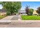 Well-maintained home with a green lawn and inviting front entrance at 2535 S Julian St, Denver, CO 80219