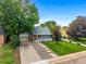 Charming home with a cozy front porch and a lush green lawn at 2535 S Julian St, Denver, CO 80219