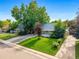 Charming home with a well-kept lawn and beautiful curb appeal at 2535 S Julian St, Denver, CO 80219