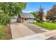 Charming gray single-Gathering home with a detached garage and walkway to the front door at 2535 S Julian St, Denver, CO 80219