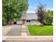 Charming gray home boasts a manicured lawn and inviting front porch, enhancing its curb appeal at 2535 S Julian St, Denver, CO 80219