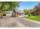 Well-maintained single-Gathering home with lush lawn, detached garage and inviting front porch at 2535 S Julian St, Denver, CO 80219