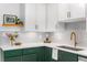 Stylish kitchen featuring quartz countertops, two-tone cabinetry, and designer fixtures at 2535 S Julian St, Denver, CO 80219