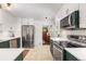 Updated kitchen featuring stainless steel appliances, tile floors, and white subway tile backsplash at 2535 S Julian St, Denver, CO 80219
