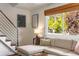 Bright living room with a sectional sofa, large window and a modern staircase at 2535 S Julian St, Denver, CO 80219