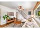Bright living room featuring a sectional sofa, hardwood floors, and a modern staircase at 2535 S Julian St, Denver, CO 80219