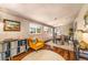 Cozy living room with hardwood floors, a yellow arm chair, and natural lighting at 2535 S Julian St, Denver, CO 80219
