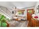 Inviting living room with hardwood floors, sectional sofa, and a stylish wooden door at 2535 S Julian St, Denver, CO 80219