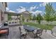 Large backyard space with covered patio and wrought iron table and chairs at 5789 Echo Park Cir, Castle Rock, CO 80104