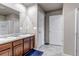 Bathroom with double vanity, wood cabinets, tile floor and separate toilet room at 5789 Echo Park Cir, Castle Rock, CO 80104