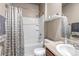 Bright bathroom featuring a tub with white tiled surround and convenient storage shelf at 5789 Echo Park Cir, Castle Rock, CO 80104