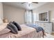 Cozy bedroom with wooden floors, a white dresser, and a comfortable bed with pillows and blankets at 5789 Echo Park Cir, Castle Rock, CO 80104