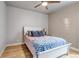 Bedroom featuring a white bed frame with blue and white patterned bedding and wooden floors at 5789 Echo Park Cir, Castle Rock, CO 80104