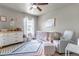 Cozy Bedroom with crib, comfortable chair, and colorful rug at 5789 Echo Park Cir, Castle Rock, CO 80104