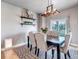 Dining room with a modern chandelier, a table with six chairs, and sliding glass doors to the outside at 5789 Echo Park Cir, Castle Rock, CO 80104