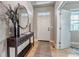 Welcoming entryway boasts stylish console table, sleek mirror, modern decor and natural light at 5789 Echo Park Cir, Castle Rock, CO 80104